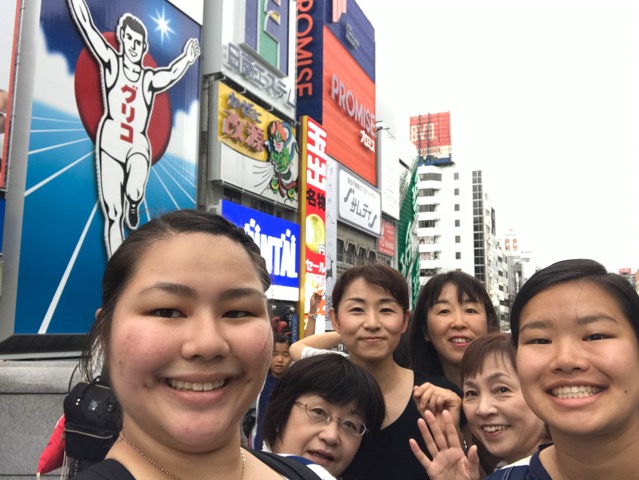 group photo in Tokyo with lighted billboards